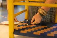 Ash Be Loved seat weaving close up of gold and blue underside