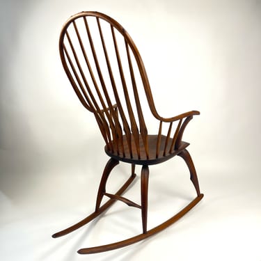 Continuous arm rocker