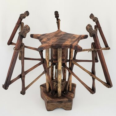 This stool points towards an occupant when the weight of a person rests on the seat. The five finger mechanisms extend and rise from beneath the seat when depressed. Once weight is released, springs pull the fingers down to their starting position and the